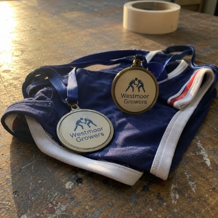 Wrestling medal resting on a folded singlet